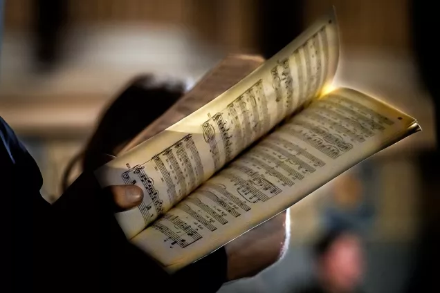 Someone is leafing through the sheet music. Photo.